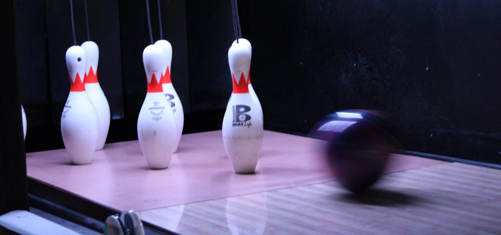 a bowling ball heading for pins