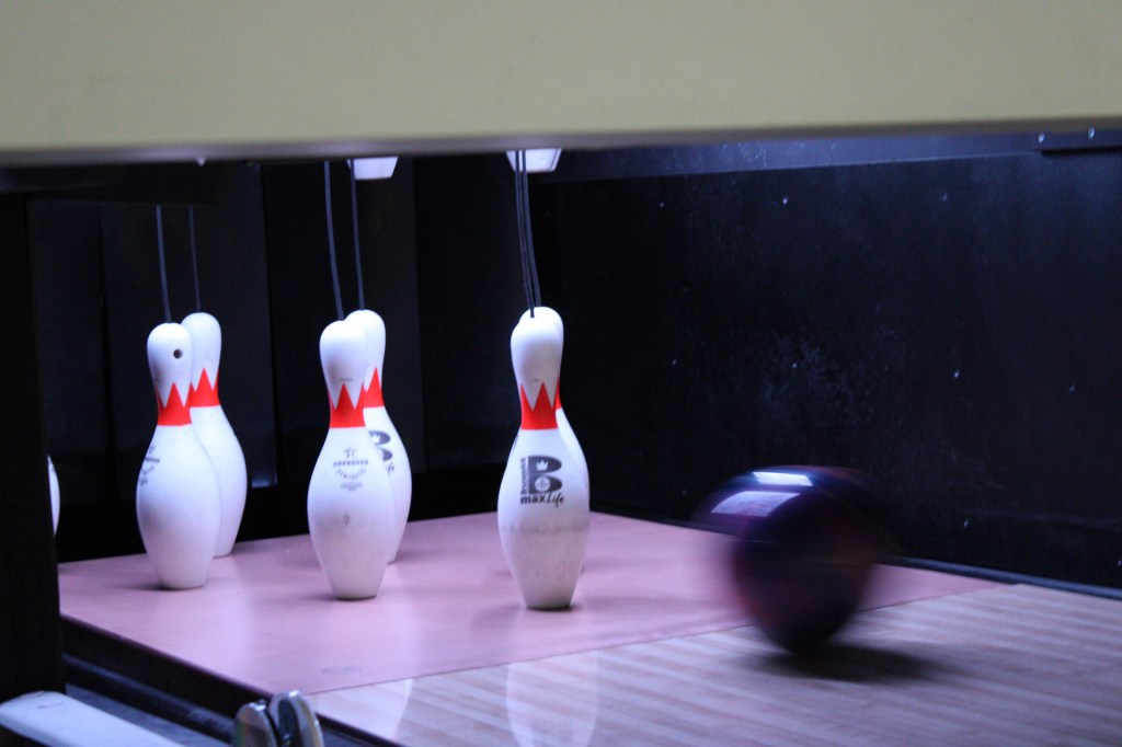 a bowling ball heading for pins