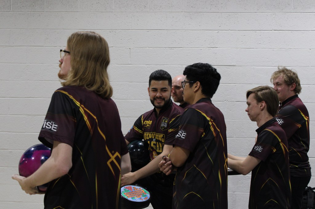 members of the ASU Bowling team watch the lanes and talk